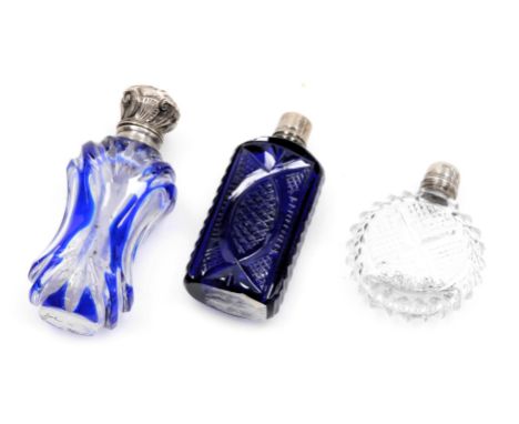 Three Victorian cut glass scent bottles, one of blue flushed waisted form, with a plated mount and hinged lid, 8cm high, a Br