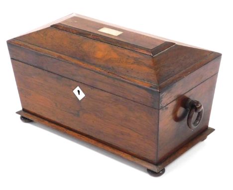 A Regency rosewood tea caddy, of sarcophagus form, with double ring handles, and mother of pearl escutcheons, the hinged lid 