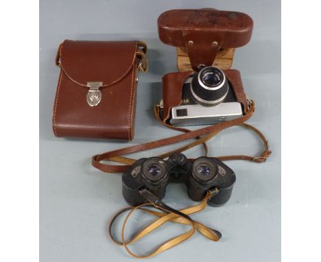 A pair of Carl Zeiss Jenoptem 8x30w binoculars together with a Werra camera having Carl Zeiss Tessar 2.8/50 lens, both in lea