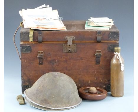 A storage trunk with hinged lid, lock and carrying handles together with contents including aircraft carrier photographs and 