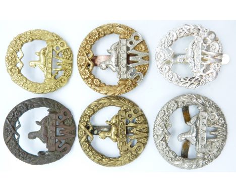 Six British Army South Wales Borderers metal cap badges
