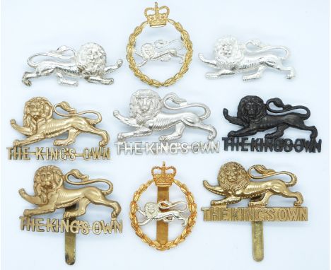 Nine British Army King's Own Regiment metal badges including a facing pair worn by tank units WWII