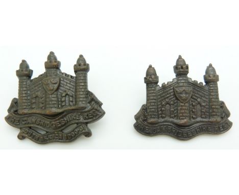 Two British Army Cambridgeshire Regiment officer's cap badges together with another similar example