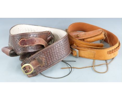 Two leather ammunition belts each with matching holsters and dummy ammunition.&nbsp;
