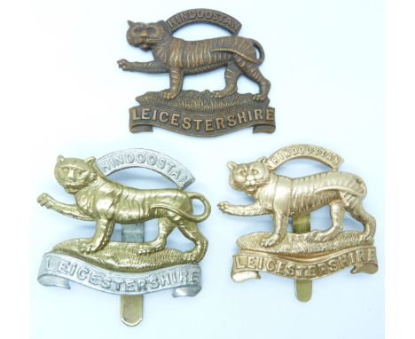 Three British Army Leicestershire Regiment metal hat badges including an all brass example