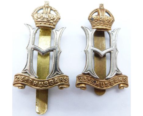 Two British army 23rd Hussars other ranks metal cap badges