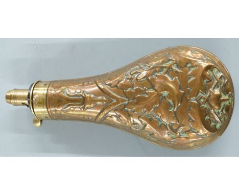 Copper and brass powder flask with embossed decoration of a stag's head, fox mask and oak leaves, 20cm long.&nbsp;