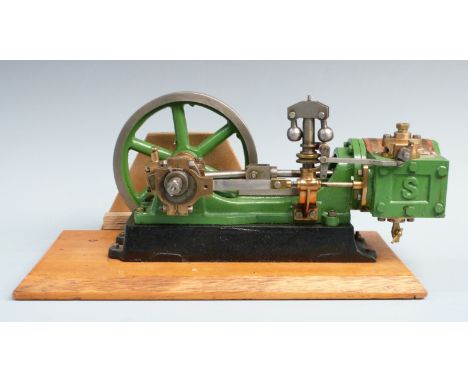 Stuart Turner No 9 live steam horizontal stationary engine with fly ball governor, on wooden display base, 33cm long.