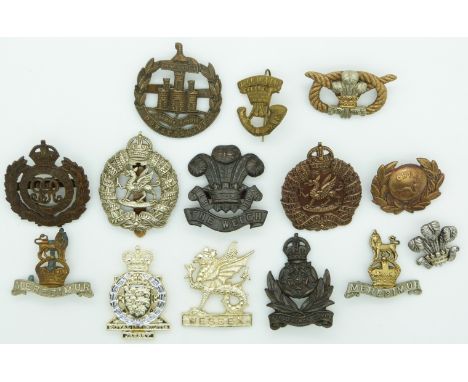 Fourteen British Army Welsh Regiment, Dorsetshire Regiment, Wessex Regiment etc metal hat badges, one by London Badge and But