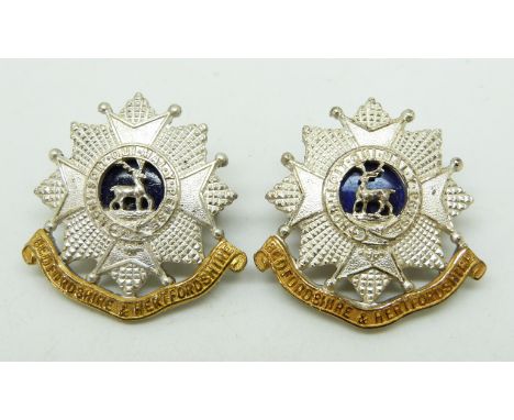 Two British Army Bedfordshire and Hertfordshire Regiment&nbsp;officer's metal collar badges, one stamped J.R.Gaunt