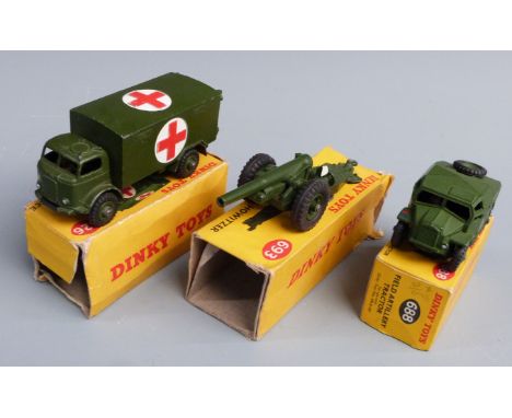 Three Dinky Toys diecast model vehicles Military Ambulance 626, Field Artillery Tractor 688 and 7.2 Howitzer 693, all in orig