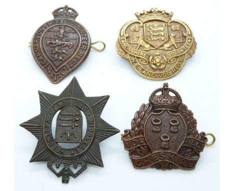 Four British Army Caernarvonshire, Middlesex, Lancashire and Cheshire Volunteer Regiment metal cap badges