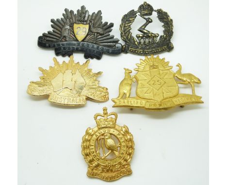 Five Australian Army 25th Regiment, 29th Regiment, 33rd Regiment and 51st Regiment metal hat badges together with an unnumber
