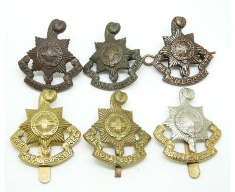 Six British Army Royal Sussex Regiment metal badges including Gaunt and Smith &amp; Wright makers
