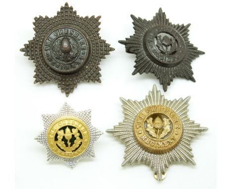 Four British Army Cheshire Regiment metal cap badges including an officer's enamel example