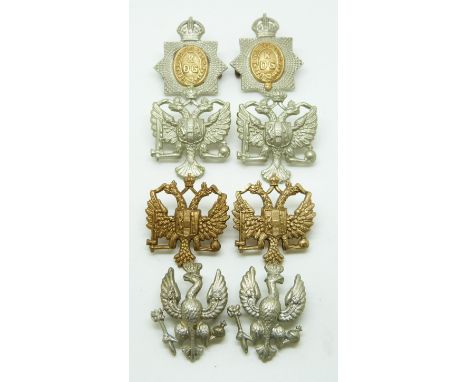 Eight British Army King's Dragoon Guards metal collar badges in four different pairs