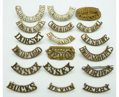 Eighteen British Army County Regiments metal shoulder titles including those for the Bedford Regiment, Brecknock Regiment, Ch