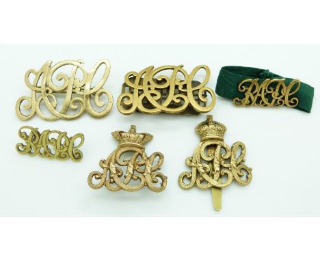 Six British Army Pay Corps metal badges including a Queen's Crown cap badge example