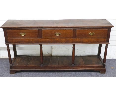 Oak three drawer dresser raised above single shelf on bracket feet, W169 x D40cm x H85cm