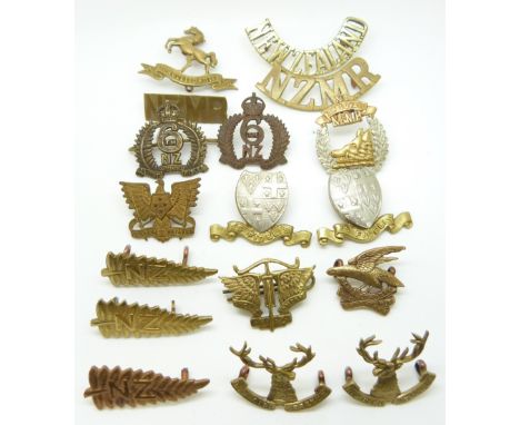 Seventeen New Zealand Army metal cap badge, collar badges and shoulder titles including 6th Manawatu Mounted Rifles, 11th Nor