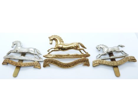 Three British Army 3rd King's Own Hussars metal cap badges including an all brass example
