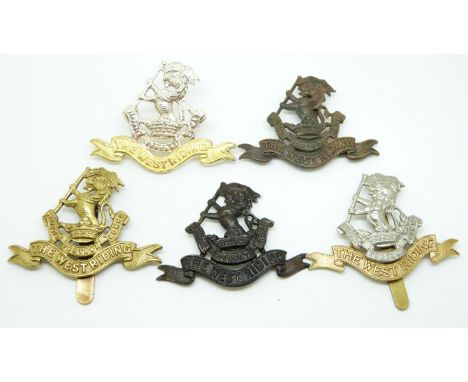 Five British Army West Riding Regiment metal cap badges including an officer's gilt example
