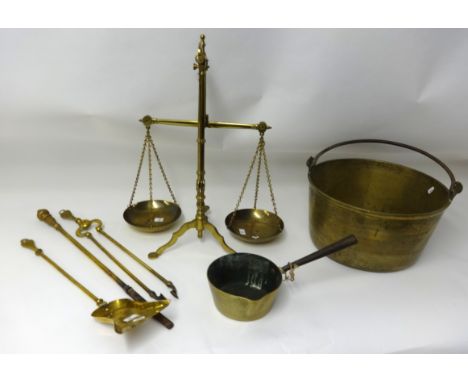 A large brass jam pan, a brass skillet, set of brass scales, weights and fire irons.