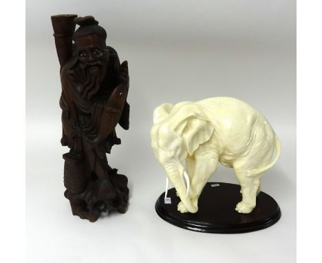 A Chinese carved wood figure table lamp and an overpainted elephant model