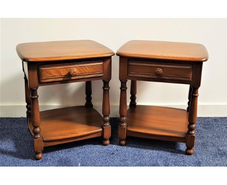 PAIR OF ERCOL STYLE DARK ELM BEDSIDE TABLESwith moulded tops above a panelled frieze drawer with a shelf below, standing on t