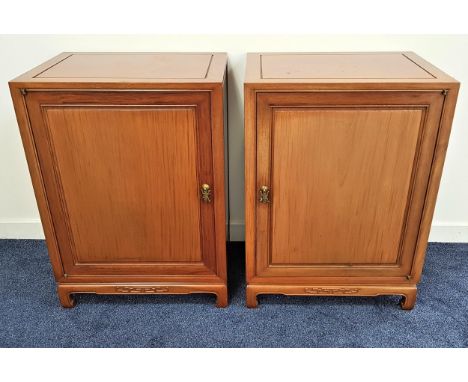 PAIR OF CHINESE TEAK CABINETS each with a panelled door opening to reveal one with three deep drawers, the other with with si