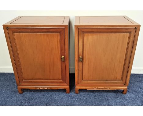 PAIR OF CHINESE TEAK CABINETS each with a panelled door opening to reveal one with three deep drawers, the other with with si