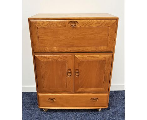 ERCOL LIGHT ELM SIDE CABINETwith a fall flap above a pair of cupboard doors with a drawer below, on later casters, 109.5cm hi