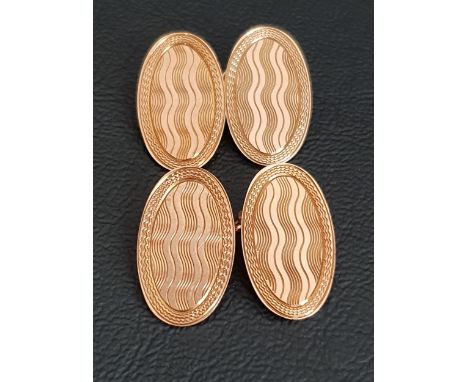 PAIR OF NINE CARAT GOLD CUFFLINKSwith oval engine turned disks with chain links, approximately 6.1 grams 