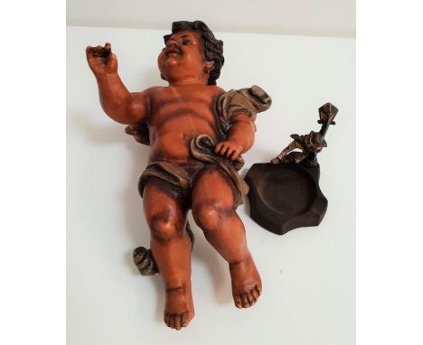 CAST IRON NOVELTY ASHTRAYdepicting a drunk clutching a lamp post, 12.5cm high, together with a resin winged cherub, 35cm high