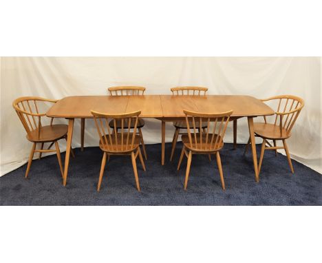 ERCOL LIGHT OAK DINING TABLE AND CHAIRSthe table with a pull apart top and two extra leaves, standing on tapering supports, 2