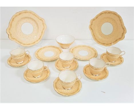 PARAGON CHINA TEA SERVICEdecorated with a peach and gilt ground with red dots, comprising six cups, eleven saucers, twelve si