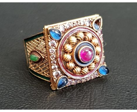 GEM, ENAMEL AND PASTE SET DRESS RINGthe central cabochon ruby in paste set decorative surround, with cabochon emeralds and gr