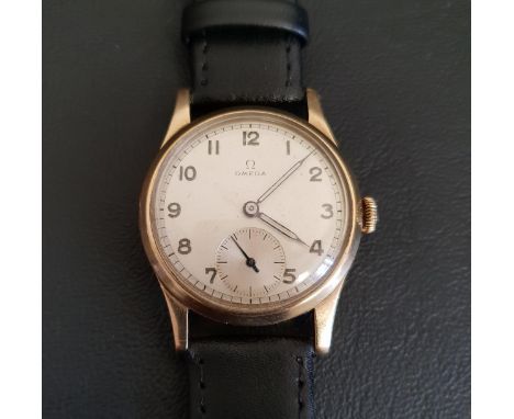 GENTLEMAN'S VINTAGE NINE CARAT GOLD CASED OMEGA WRISTWATCH dating from 1944, the dial with Arabic numerals and subsidiary sec