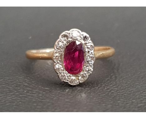 RUBY AND DIAMOND CLUSTER RINGthe central oval cut ruby in twelve diamond surround, on unmarked gold shank, ring size M 