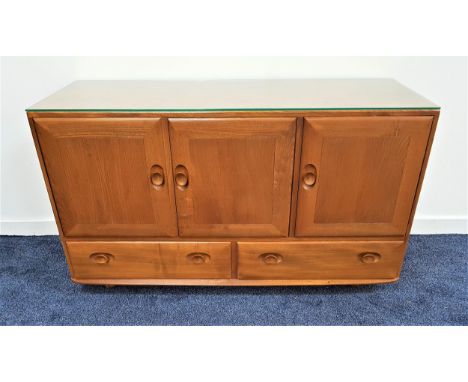 ERCOL LIGHT ELM SIDEBOARDwith three cupboard doors above two drawers, on later casters, 129cm wide 