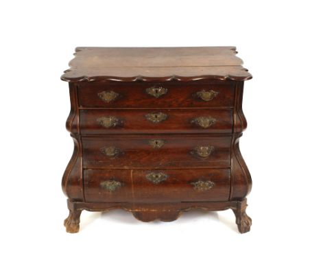 A late 18th Century oak bombe shaped serpentine commode chest, fitted four drawers and raised on ball and claw supports, 88cm