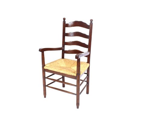 A set of eight oak ladder back and rush seated dining chairs, raised on rounded stretchered front supports, (6 standards, 2 e