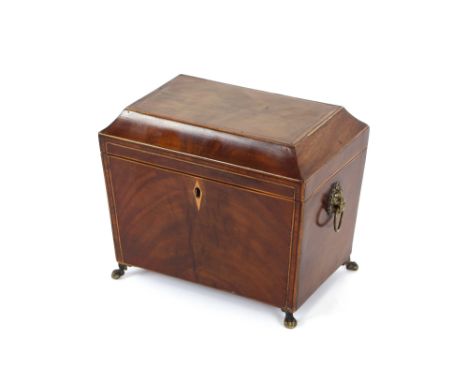 A Regency mahogany two compartment tea caddy, the interior lids with turned ivory finials, flanked by lion mask handles and r