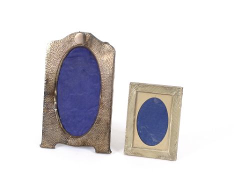 A silver spot hammered easel photograph frame; and another with engine turned and raised foliate decoration, (2)