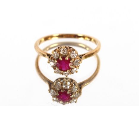 A yellow metal ruby and diamond set cluster ring