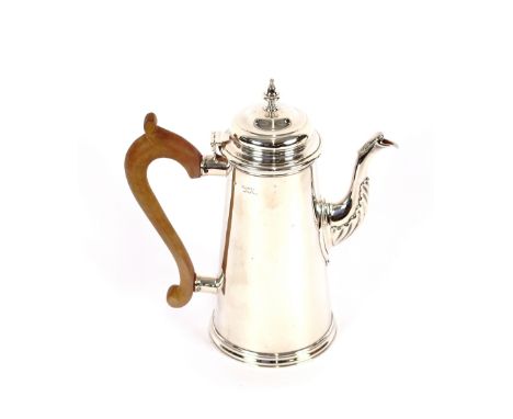 A silver coffee pot, the spout with foliate decoration, domed hinged lid surmounted by a finial above a scrolled wooden handl