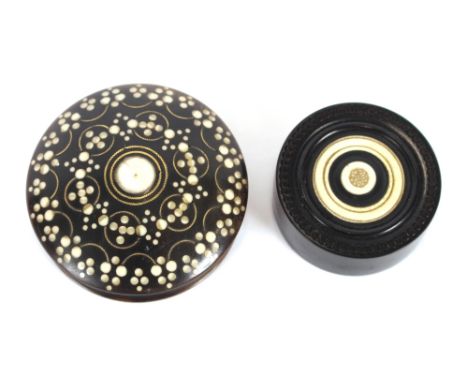 A small circular horn, ivory inlaid and pique work snuff box; and a circular ebony box with ivory inlay and stamped to the in