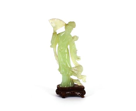 A pale jade carving, of a lady holding a fan, raised on carved hardwood stand, 26cm high