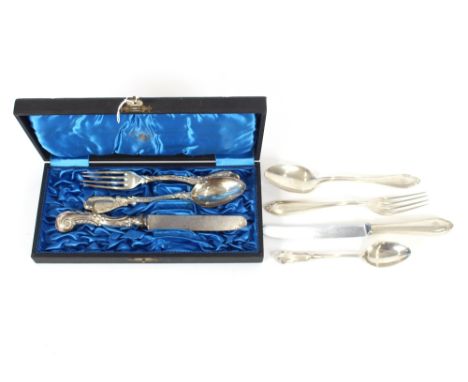 A cased .800 fork, spoon and knife, having leaf and monogrammed handles; and another fork, knife and spoon with monogrammed h
