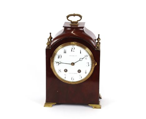A late Victorian mahogany cased mantel clock, by Maple &amp; Co., the circular white enamel dial supporting an 8 day movement